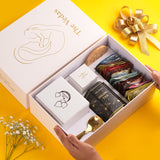 The Vedas Gift For MOM | 22 items | 8 Different Flavours teabags | 1 Luxury Oolong tea tin Caddy | total 56 Cups of tea | 1 Glass Mug for MOM With lid and Infuser | 1 Scented Candle | 1 Branded Spoon | 1 Wooden Coaster